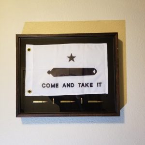 Framed historical flag with rifle and star