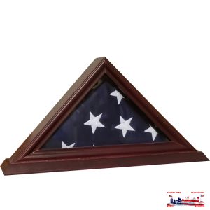 Folded American flag in a wooden display case.