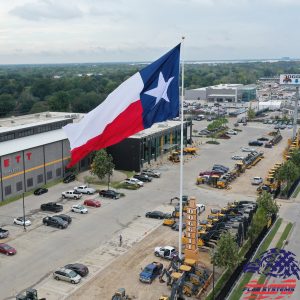 Texas flag flying above industrial area.