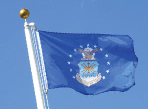 The United States Air Force flag waving against a clear blue sky.