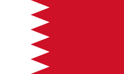 The national flag of Bahrain with a white serrated band and red field.